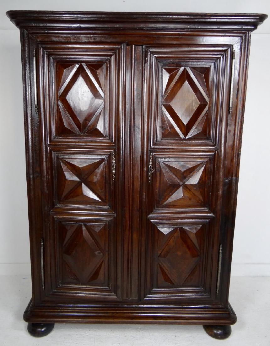 LOUIS XIII OAK AND WALNUT ARMOIRE: LOUIS XIII STYLE MIXED OAK AND SOLID WALNUT ARMOIRE HAVING HEAVY MOLDED CORNICE OVER 2 DIAMOND AND QUATREFOIL PYRAMID FORMED DOORS ON SIMILAR HEAVY MOLDED BASE ENDING ON BUN FEET, 19TH C.; 78"H X 56"W