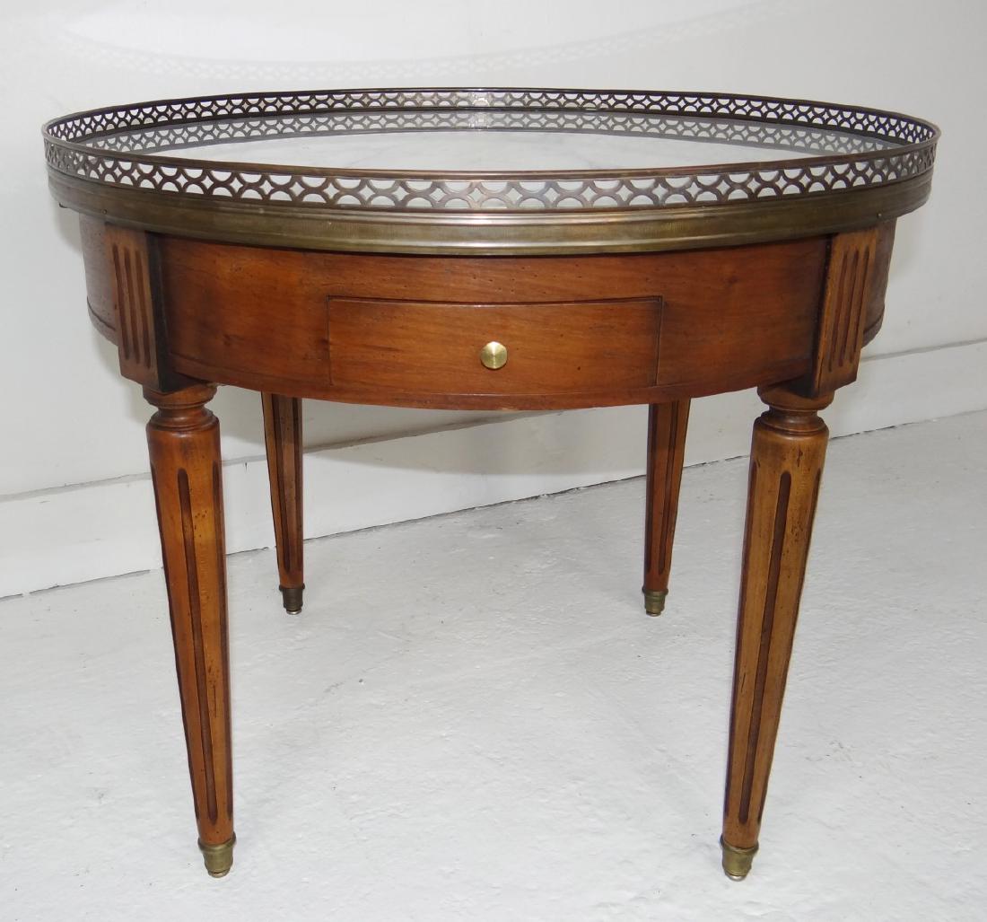 CUSTOM LOUIS XVI STYLE FRUITWOOD GUERIDON: CUSTOM LOUIS XVI STYLE FRUITWOOD GUERIDON HAVING OPEN WORK BRONZE GALLERY OVER A 2 DRAWER AND 2 PULL-OUT SLIDE FRIEZE RESTING ON FLUTED TAPERD LEGS ENDING ON BRONZE CAPS; 21"H X 24.5"DIA