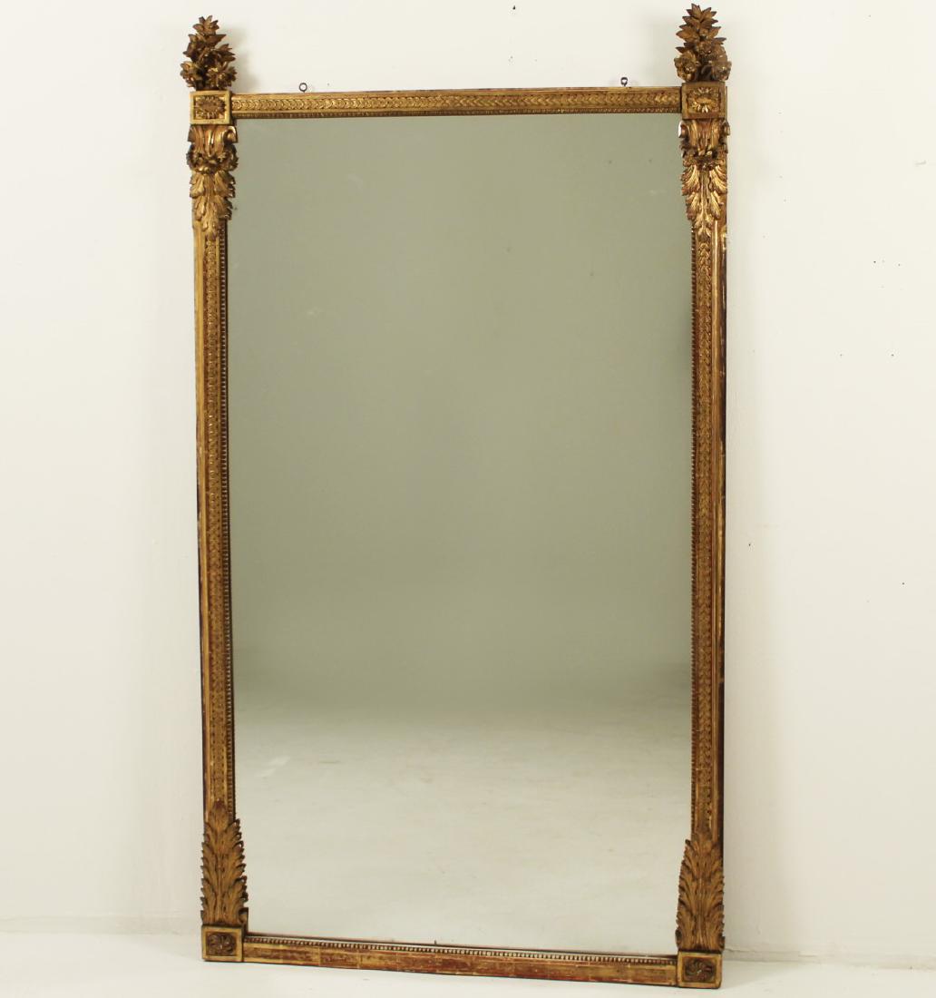 LARGE FRENCH CARVED WATER GOLD GILTWOOD MIRROR: LARGE FRENCH REGENCE INFLUENCE CARVED WATER GOLD GILTWOOD MIRROR HAVING FLORAL BOUQUET FINIALS OVER A CONTINUOUS MODIFIED CORN AND BEADED FREIZE WITH ANCANTHUS SCROLLS AND FLORAL LEAF ACCENTS, 19TH C.