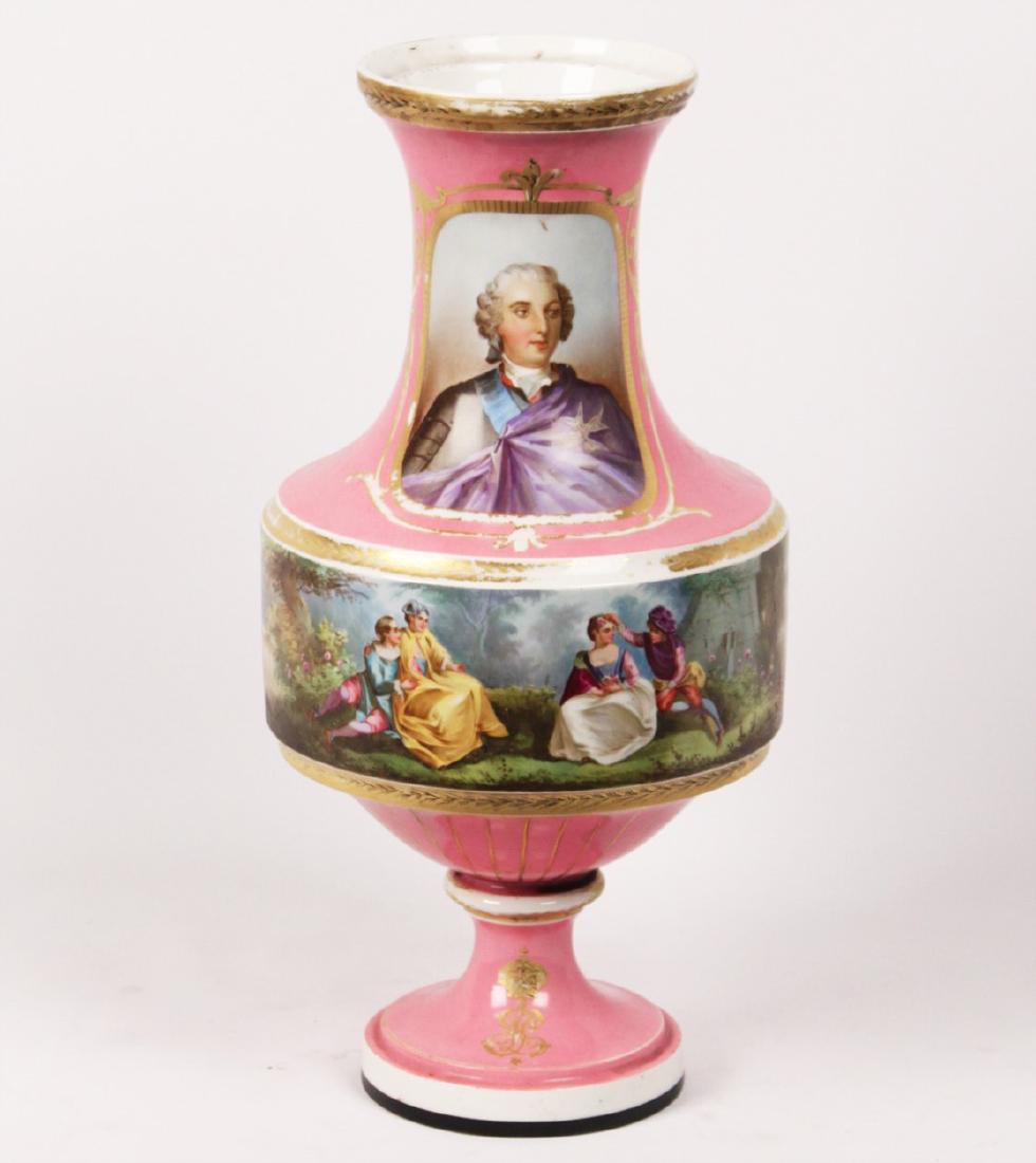 FRENCH SEVRES AND GILT PORCELAIN 17.5" URN: FRENCH SEVRES AND GILT PORCELAIN URN HAVING PAINTED COURTING SCENES ON A PINK GROUND; 17.5"H; CONDITION: AREAS OF LOSS AND WEAR TO GOLD GILDING