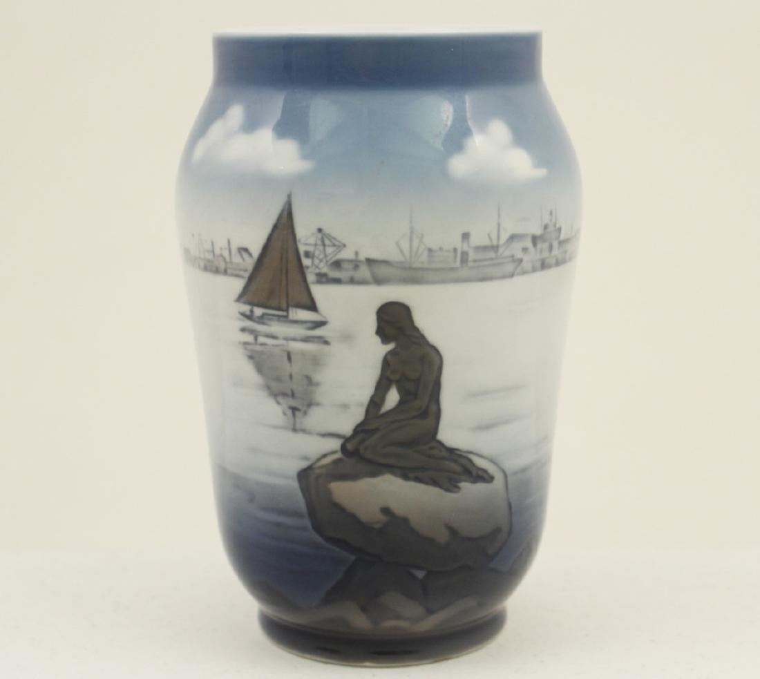 ROYAL COPENHAGAN VASE LITTLE MERMAID OF LANGELINIE: ROYAL COPENHAGAN VASE DEPICTING "THE LITTLE MERMAID" BY EDVARD ERICKSON. THE SCULPTURE OVERLOOKS THE COPENHAGEN HARBOR AT LANGELINIE PROMENADE AND PIER. MARKED ON REVERSE, TITLED "LANGELINIE"; 6.75"H;