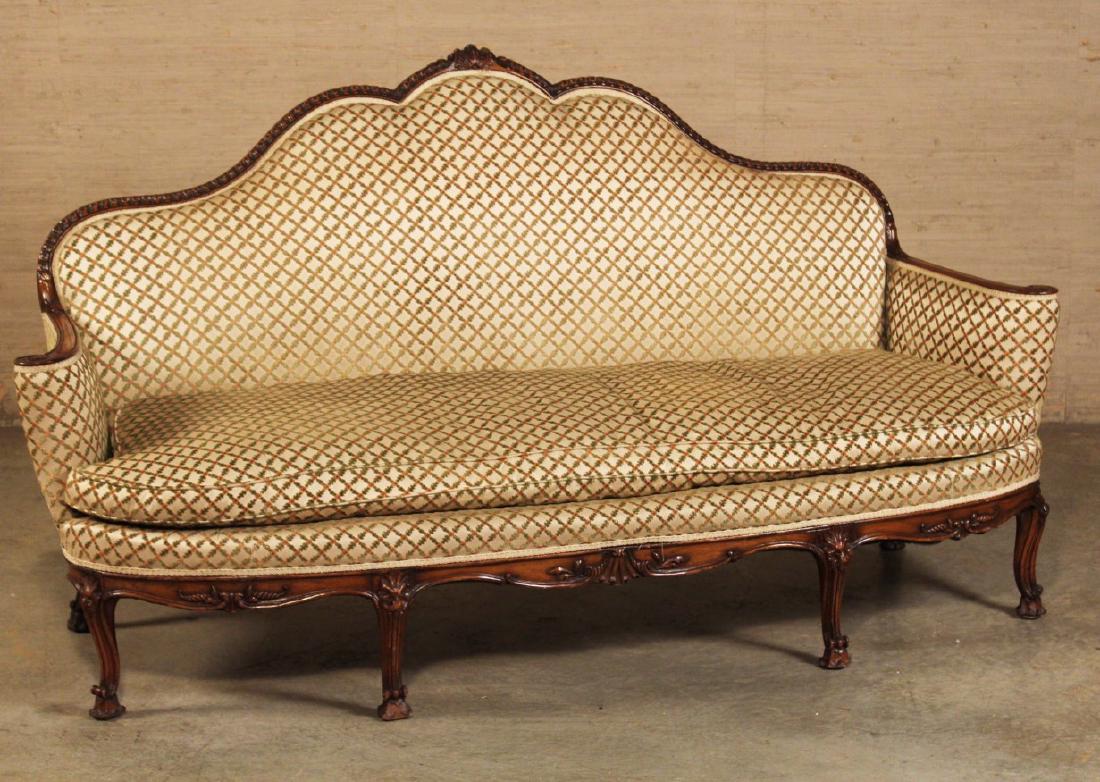 19TH C. ENGLISH MAHOGANY CARVED SOFA: ENGLISH MAHOGANY CHIPPENDALE INSPIRED SOFA HAVING CARVED ARCH BACK WITH SHELL CENTER MOTIF, ALONG WITH BOWFRONT SIMILAR TREATED APRON RESTING ON CABRIOLE LEGS AND ROCOCO INSPIRED CARVED FEET, 19TH C; 