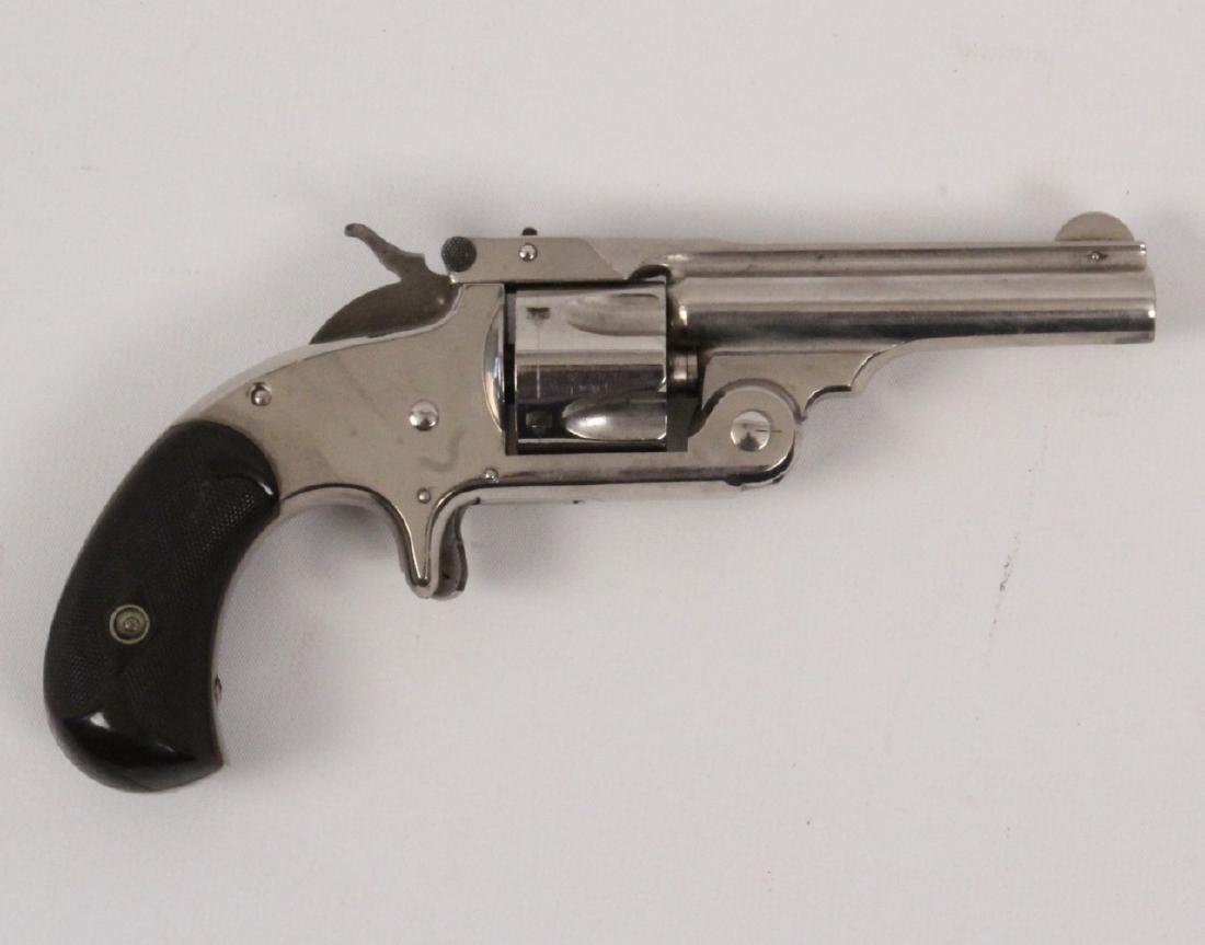 Smith and Wesson model 1.5 3rd issue nichel top break: A Smith and Wesson model 1.5 3rd issue nichel top break round butt revolver in 32 caliber with a 3 inch barrel. This Smith and Wesson is in nice condition. **ONE OWNE
