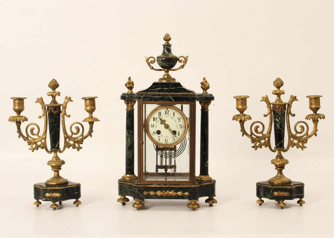 FRENCH 3 PC. CLOCK SET: 3 PIECE EMPIRE STYLE VERDE MARBLE AND GILT BRONZE MOUNTED GARNITURE CONSISTING OF A DOME SHAPED CLOCK WITH ROMAN NUMERAL ENAMEL DIAL HAVING GILT BRONZE CHAPTER RING AND APPLIED LYRE MOTIF, ALONG WITH 