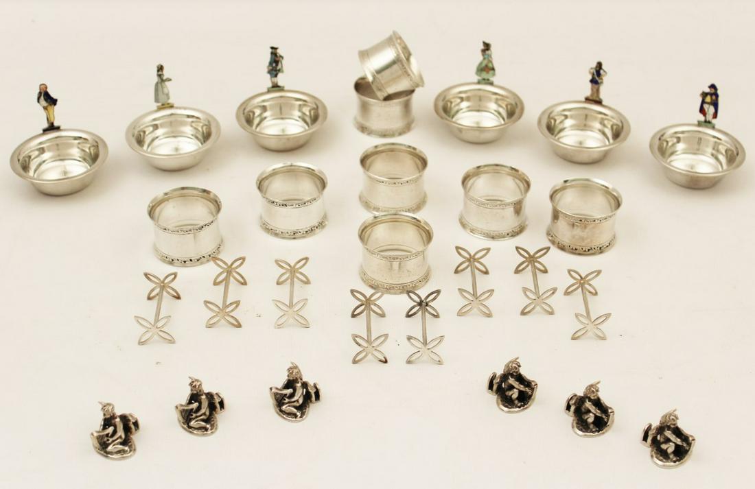 28 PC. MISC. LOT OF STERLING TABLE ITEMS: 28 PIECE MISCELLANEOUS LOT OF STERLING TABLE ITEMS CONSISTING OF SET OF 6 STERLING MENU HOLDERS WITH ENAMEL FIGURAL HANDLES, 8 NAPKIN RING HOLDERS, 6 CUPID PLACE CARD HOLDERS, 8 KNIFE RESTS; 19 TROY O