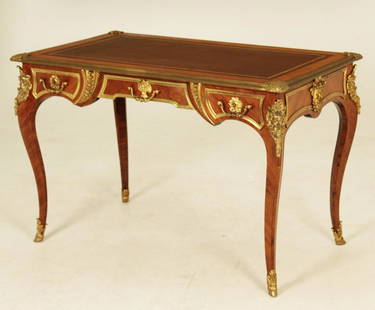 IMPORTANT SIGNED PAUL SORMANI BUREAU PLAT: PAUL SORMANI, LOUIS XV STYLE TULIPWOOD BUREAU PLAT HAVING CENTER LOCKING PLATES, SIGNED PAUL SORMANI; PARIS 10 RUE CHARLOT, LATE 19TH C., DEEP BROWN TOOLED LEATHER INSERT TOP SURROUNDED BY ORMULU MOUN