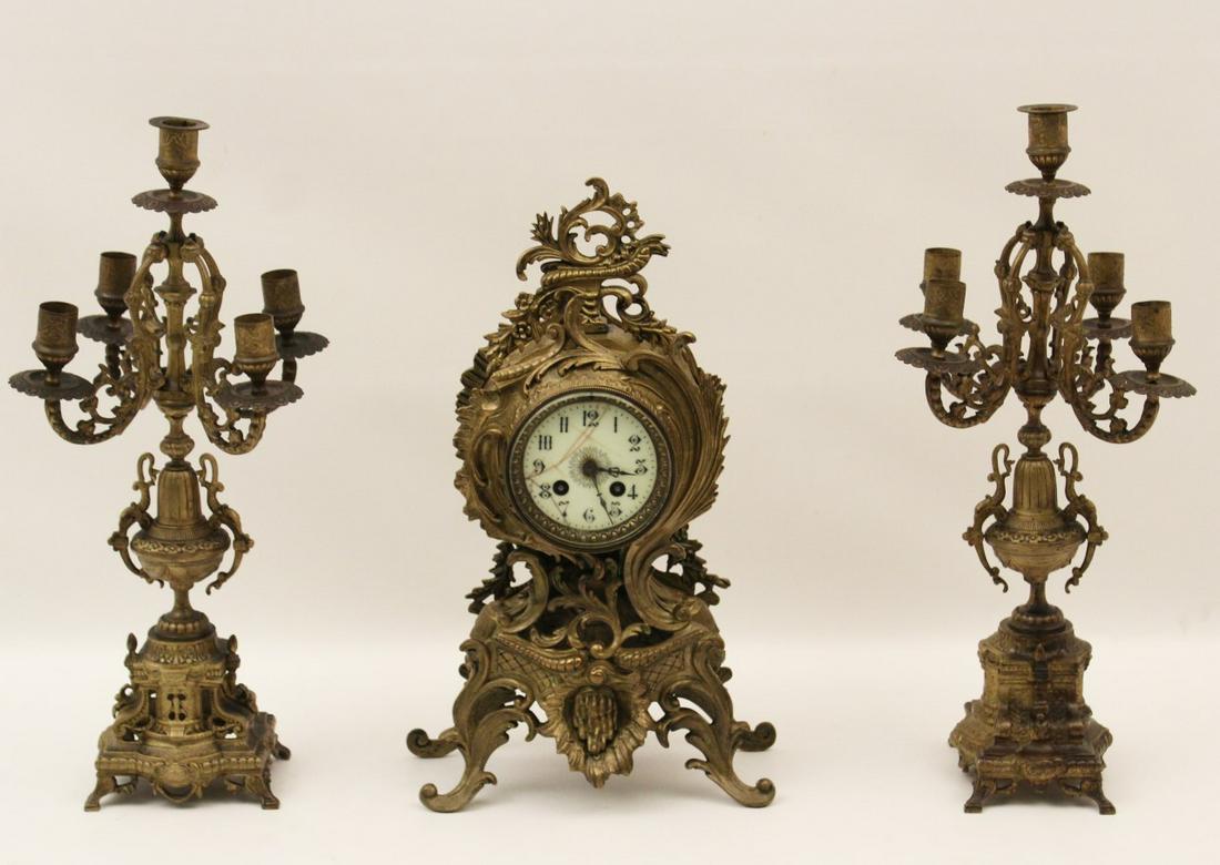 FRENCH 3 PC. METAL CLOCK SET: FRENCH 3 PIECE PATINATED METAL CLOCK SET CONSISTING OF CLOCK AND PAIR OF 5 LIGHT CANDELABRA; 16.5"H CLOCK; CONDITION: DIAL CRACK, CLOCK AS FOUND