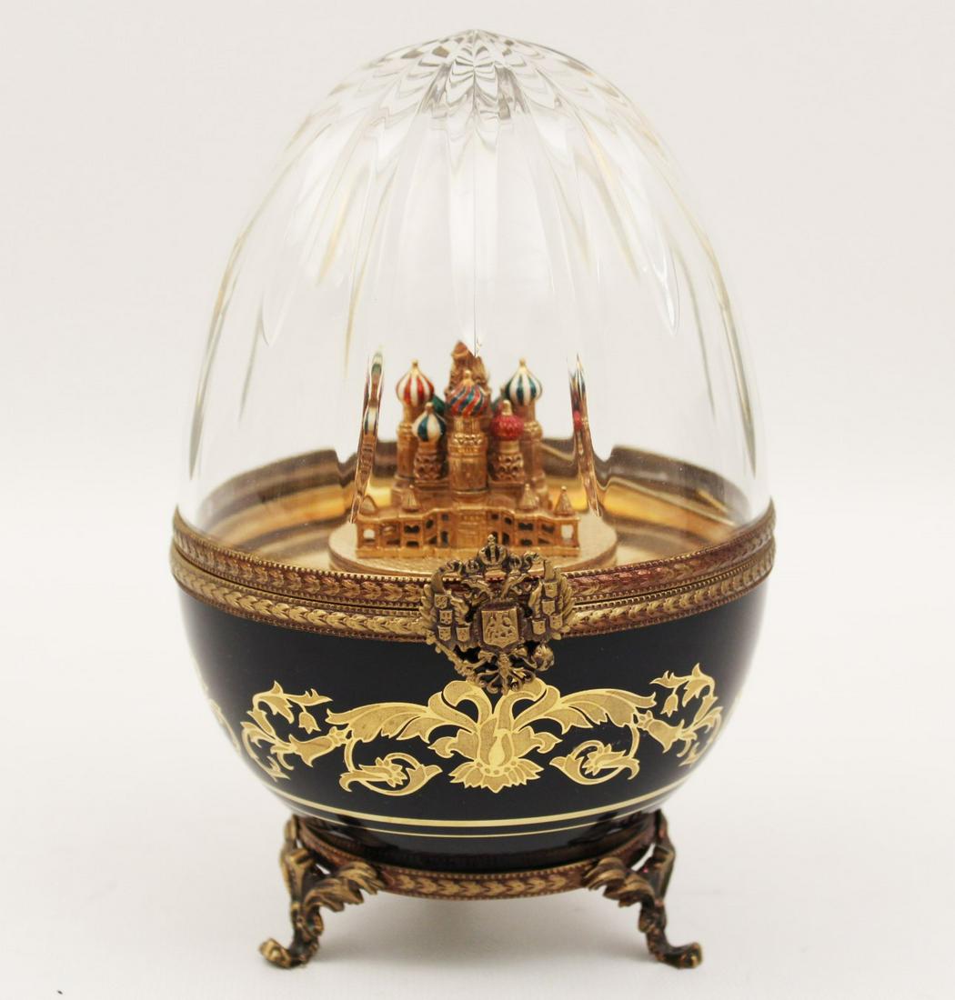 FABERGE IMPERIAL EGG MUSIC BOX BY LIMOGE: FABERGE IMPERIAL EGG MUSIC BOX BY LIMOGE HAVING A CUT CRYSTAL DOMED TOP WITH COAT OF ARMS LATCH OPENING TO REVEAL ST. BASIL'S CATHEDRAL, INSCRIBED FABERGE AND NUMBERED 206, AND MARKED ON REVERSE "TATI