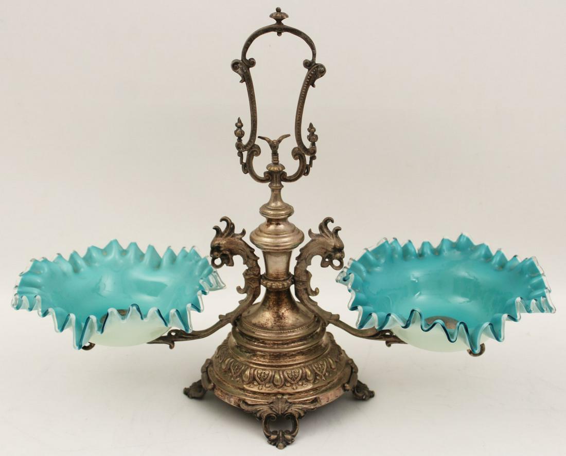 VICTORIAN SILVER ART GLASS EPERGNE: VICTORIAN SILVER ART GLASS EPERGNE HAVING OPEN ELONGATED "C" SCROLL HANDLE WITH BIRD SURMOUNT OVER 2 DRAGON FORMED ARMS SUPPORTING RIBBON EDGE HANDBLOWN BOWLS RESTING ON A CIRCULAR PEDESTAL AND FOOTED