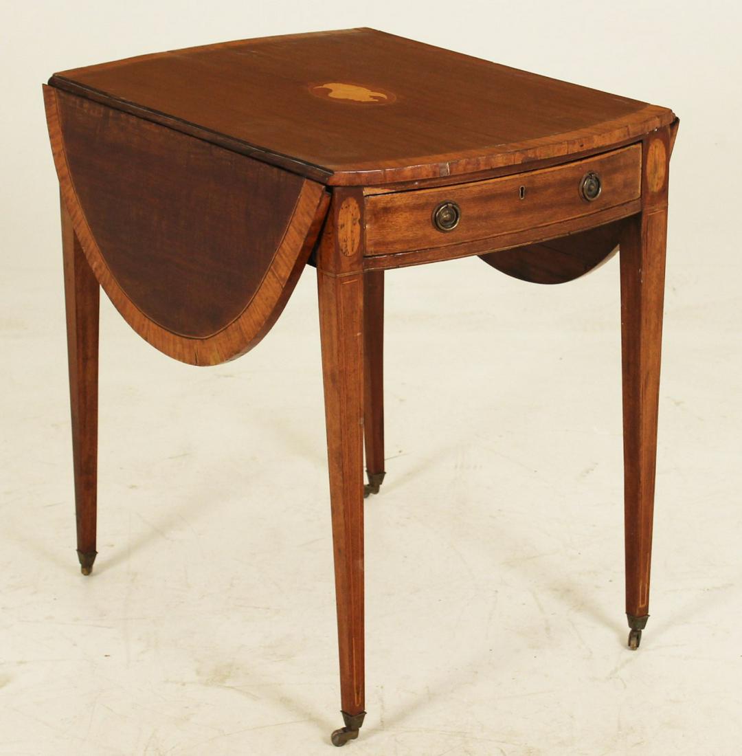 INLAID HEPPLEWHITE MAHOGANY BOW END PEMBROKE TABLE: INLAID HEPPLEWHITE MAHOGANY BOW END PEMBROKE TABLE HAVING SATINWOOD CROSSBANDED TOP WITH CENTER SHELL INLAY OVER ONE DRAWER SUPPORTED BY FAN INLAID TAPERD LEGS ON CUP CASTERS; 29"H X 20"W X 31.5"D; CO