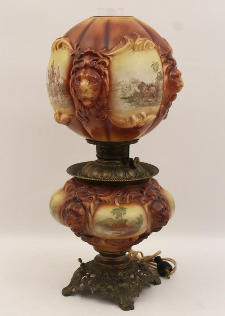 HIGHLY UNUSUAL GONE WITH THE WIND LAMP: HIGHLY UNUSUAL GONE WITH THE WIND LAMP WITH QUILTED FORM GLASS SHADE AND BASE HAVING INDIVIDUAL HAND PAINTED VIGNETTES FROM THE AFRICAN CONTINENT SEPARATED BY RAISED LION HEAD DESIGNS; 23"H X 10"W