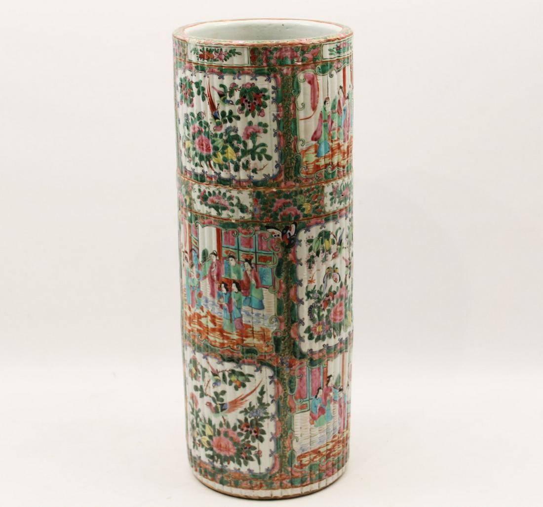 FAMILLE ROSE PORCELAIN UMBRELLA STAND, 19TH C.: FAMILLE ROSE EXPORT CONTINUOUS BAMBOO SHOOT FORMED UMBRELLA STAND WITH ALTERNATING VIGNETTES OF EXOTIC BIRDS, BUTTERFLIES AND FLYING INSECTS AMONGST FRUIT AND FOLIATED VINES, AND FIGURES IN COURTYARD 