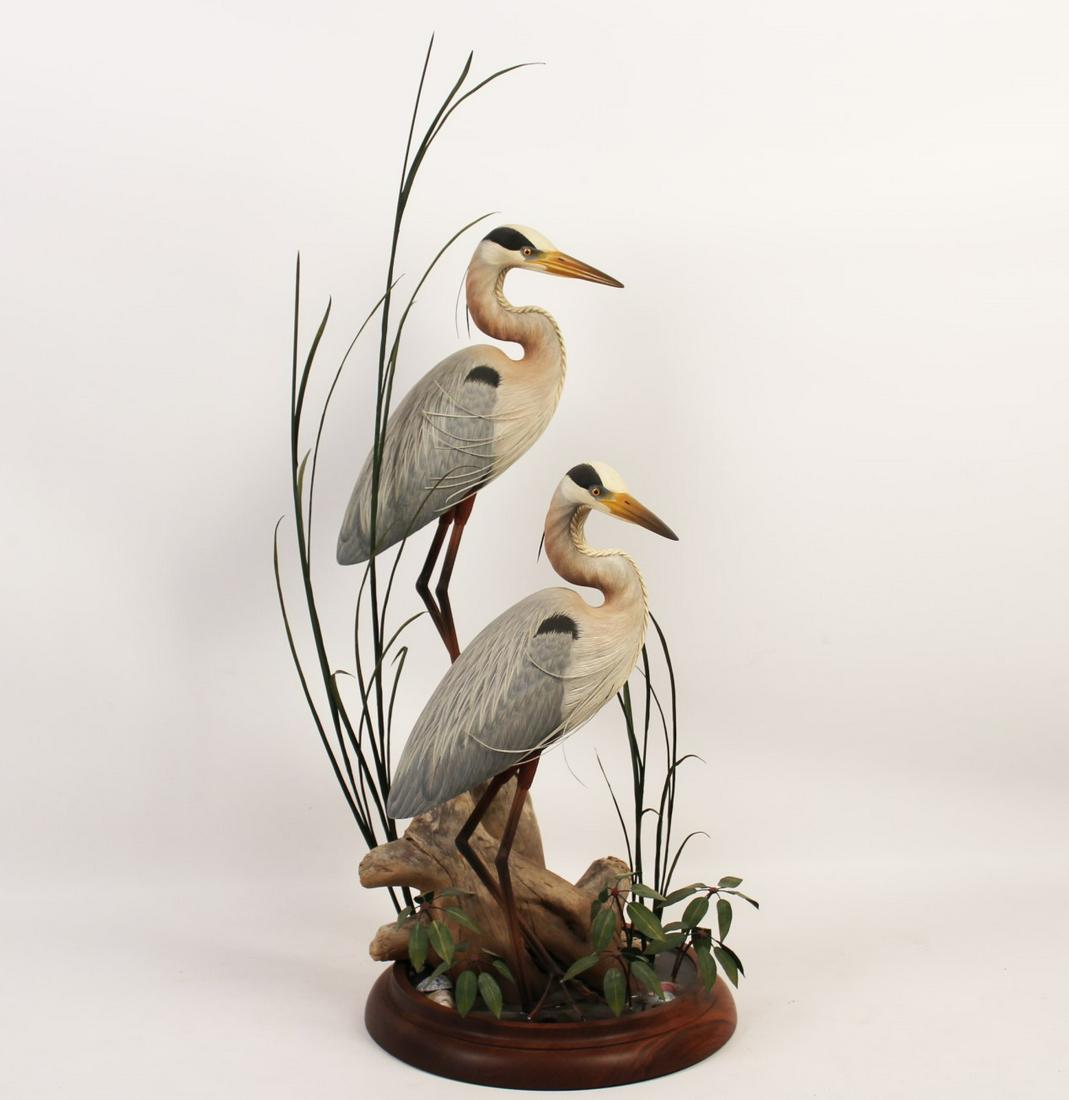 CARVED WOOD SCULPTURE OF HERONS BY DAN WILLIAMS: COMMISSIONED CARVED WOOD SCULPTURE OF PAIR OF GREAT BLUE HERONS MODELED IN A MARSH WETLAND BY DAN WILLIAMS, OWINGS MILLS, MD; WITH ORIGINAL BILL OF SALE