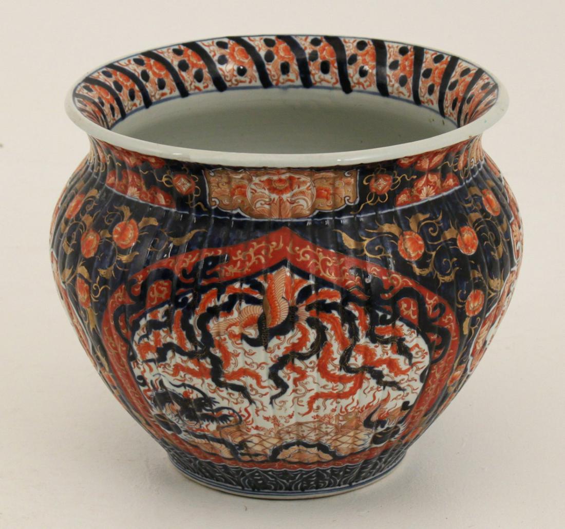 IMARI MEIJI PERIOD RIBBED PORCELAIN FISH BOWL: IMARI MEIJI PERIOD RIBBED SHAPED PORCELAIN FISH BOWL WITH HIGHLY STYLIZED DECORATION OF DRAGONS AND BIRDS IN FOLIATED RESERVES; 14.5"H X 17"W