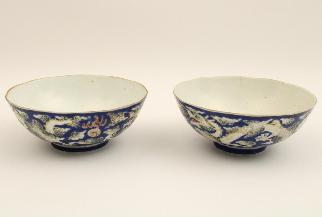 PR OF QING DYNASTY PORCELAIN FOOTED BOWLS: PAIR OF QING DYNASTY PORCELAIN BLUE ENAMEL OUTLINED FOOTED BOWLS HAVING 5 CLAW DRAGON IN A MYTHOLOGICAL SETTING WITH RUYI CLOUDS SEPARATED BY RED FLAMES, THE TOP RIMS SLIGHTLY SCALLOPED WITH GOLD RIM