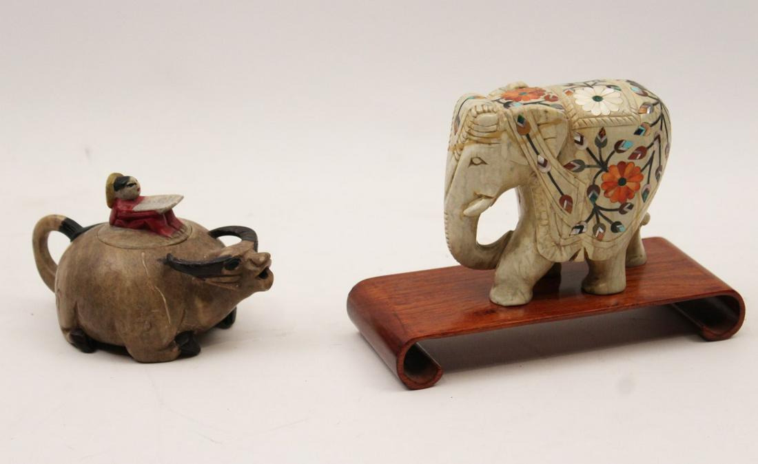 2 PC. MISC. LOT OF SOAPSTONE: 2 PIECE MISCELLANEOUS LOT OF SOAPSTONE CONSISTING OF AN OXEN FORMED TEAPOT HAVING COVER WITH FIGURES READING BOOK; ALONG WITH EXOTIC INLAID ELEPHANT ON TEAKWOOD STAND; 4"H X 4.5"LONG X 2.5"W ELEPHANT;