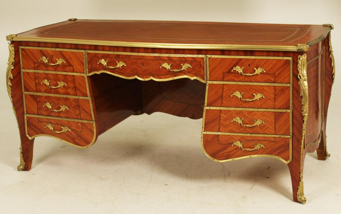 LOUIS XV STYLE BRONZE MOUNTED SERPENTINE KINGWOOD: LOUIS XV STYLE BRONZE MOUNTED SERPENTINE KINGWOOD BUREAU PLAT HAVING TOOLED LEATHER INSET TOP OVER 9 CONFORMING DRAWERS WITH FINE PARQUETRY PANELS RESTING ON CABRIOLE LEGS AND BRONZE SABOTS, 20TH C.; 