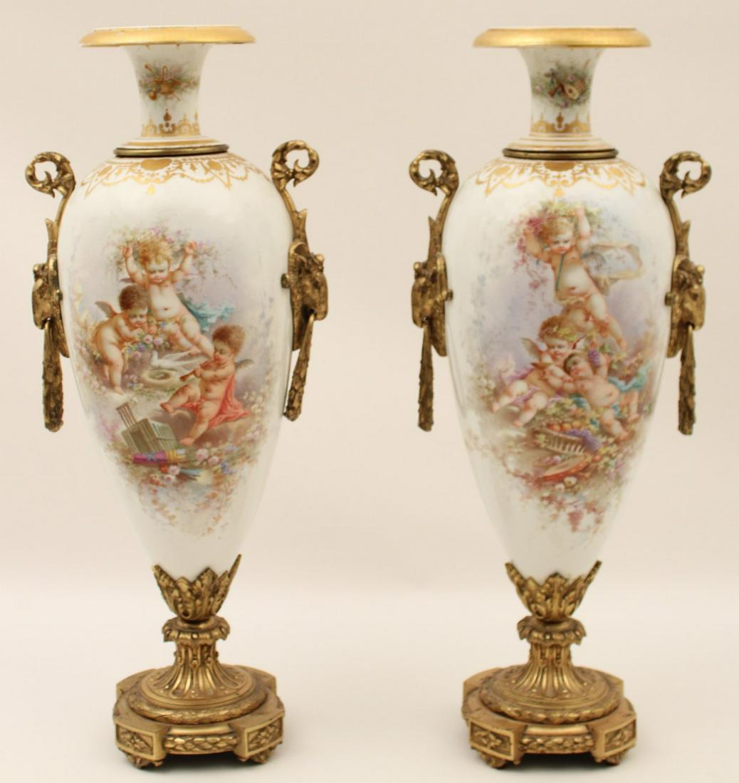 PR OF FRENCH SEVRES PORCELAIN VASES, 19TH C.: PAIR OF FRENCH SEVRES PORCELAIN VASES, THE MAIN BODY HAVING VIGNETTES OF PLAYFUL PUTTI AMONGST GRAPEVINES, BIRDS AND MUSICAL INSTRUMENTS, THE REVERSE PAINTED WITH COMPLIMENTARY TROPHIES, GILT BRONZE M