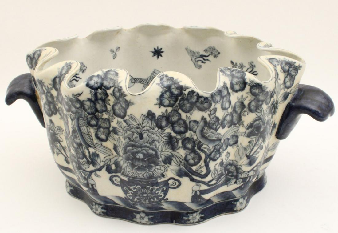 LOBE SHAPED ORIENTAL PORCELAIN FOOT TUB: DECORATIVE LOBE SHAPED ORIENTAL BLUE AND WHITE PORCELAIN INDIGO HANDLED FOOT TUB HAVING VIGNETTES OF BIRDS IN A FOLIATED RESERVE; 8"H X 19"W X 12"D