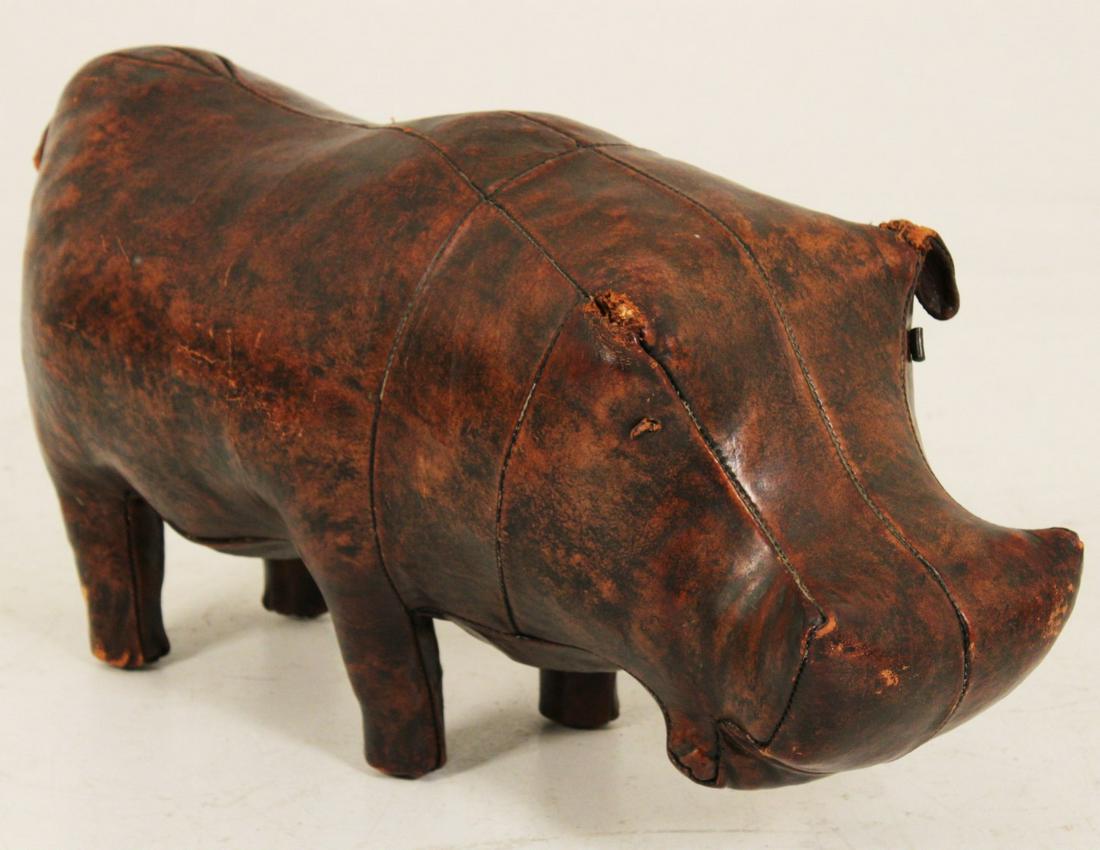 LEATHER HIPPOPOTAMUS, RETAILED BY ABERCROMBIE & FITCH: BROWN LEATHER HIPPOPOTAMUS RETAILED BY ABERCROMBIE & FITCH; 14"H X 35"W X 12"D; CONDITION: MISSING EAR AND WEAR TO EAR OF HIPPO