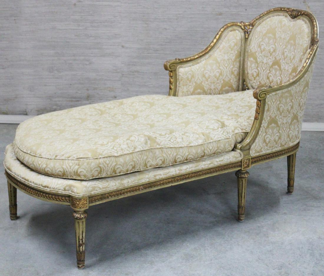 LOUIS XVI STYLE CARVED GILTWOOD CHAISE: LOUIS XVI STYLE CARVED GILTWOOD CHAISE HAVING LEAF AND CONTINUOUS FESTOON CARVED TRI-FORMED BACK WITH REPEATED COIN DESIGN FRAME RESTING ON TRUMPET FLUTED TAPERD LEGS, UPHOLSTERED IN COORDINATING GOLD