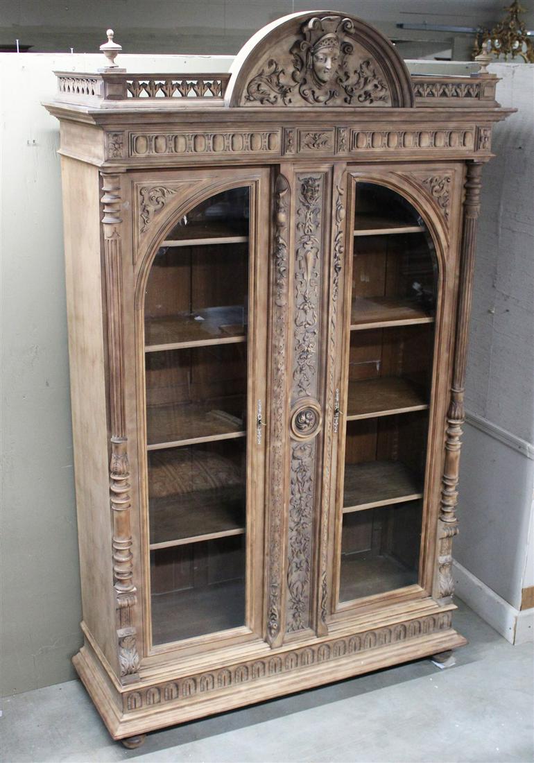 FRENCH RENAISSANCE REVIVAL BIBLIOTHEQUE: FRENCH FRUITWOOD RENAISSANCE REVIVAL BIBLIOTHEQUE WITH RETICULATED AND DOME CARTOUCHE CARVED GALLERY OVER AN ELABORATE DETAILED 2 BEVEL GLASS DOORS ENCOMPASSED BY REEDED FULL LENGTH COLUMNS; 102"H X 5