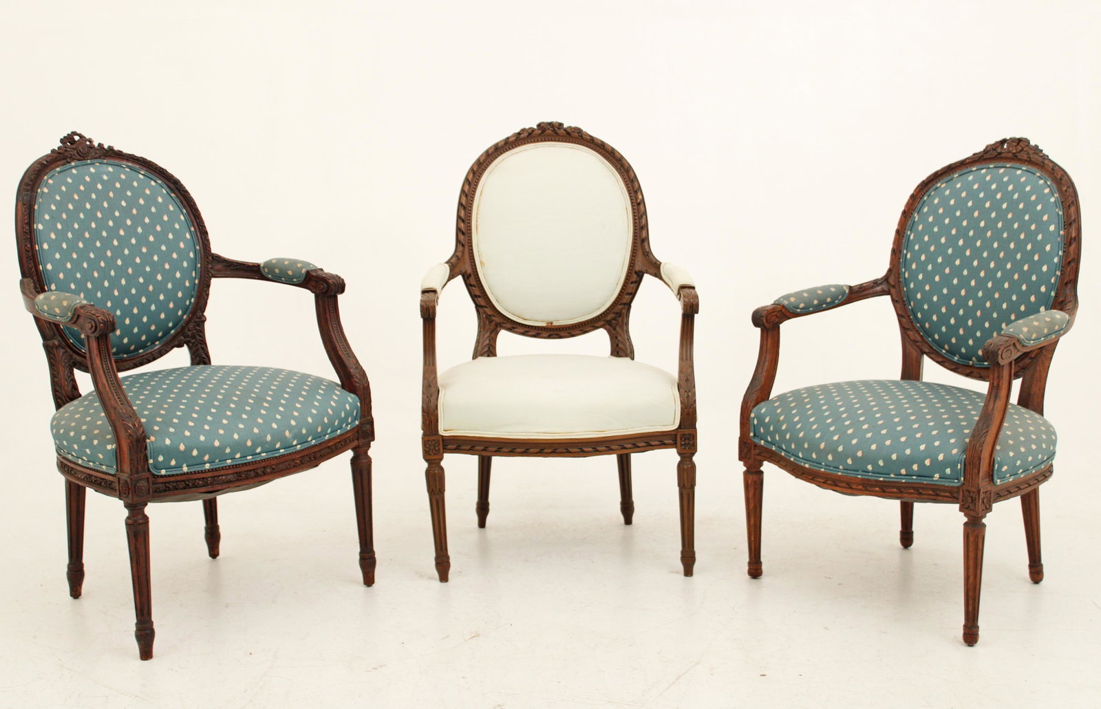 Group of 3 Louis XVI style carved walnut armchairs: Group of 3 Louis XVI style carved walnut armchairs with gadroon carved back famed and seat rail resting on reeded taperd legs; 36.5"H 24"W 21"D
