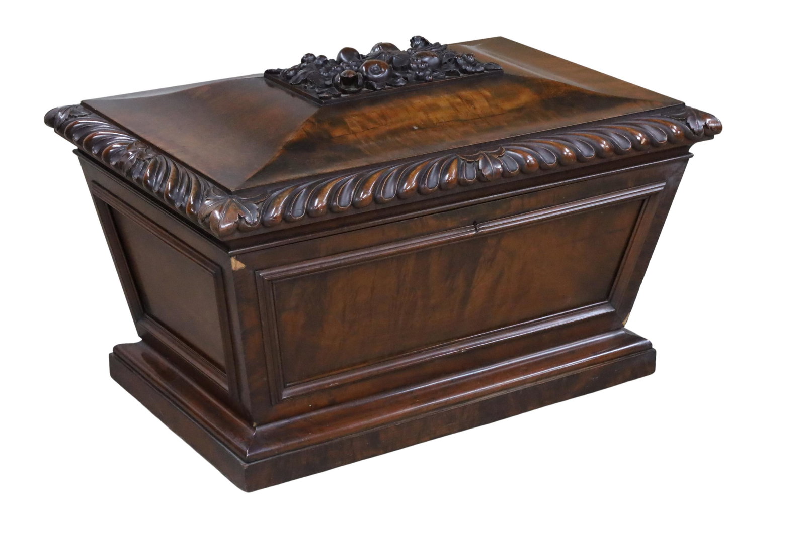 ENGLISH MAHOGANY WINE SARCOPHAGUS: English Mahogany Wine Sarcophagus having a hinged quatrefoil raised platform top with a floral carved plateau over gadroon lip, with a tapered body on a molded plinth; 24"H 39"W 22"D