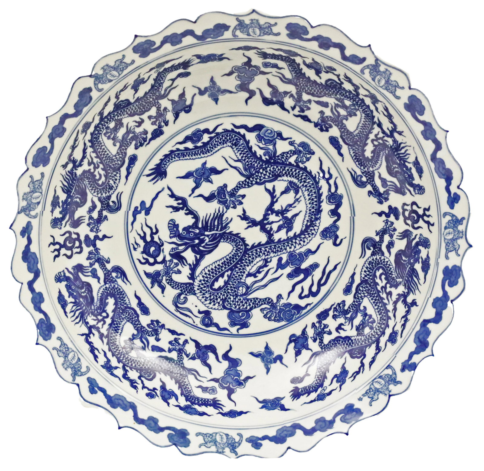 16" CHINESE BLUE & WHITE PORCELAIN DRAGON CHARGER: Chinese blue and white porcelain charger with scalloped edges, outer border of clouds and bats with four dragons encompassing a center dragon reserve, marked with apocryphal Yongzheng archaic seal mar