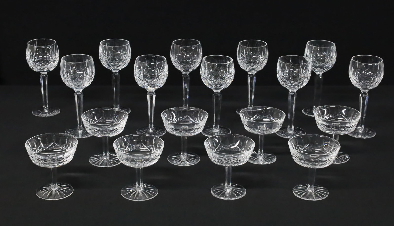 18 PC WATERFORD LISMORE WINE AND CHAMPAGNE: Eighteen piece lot of Waterford crystal stemware, Lismore Patter, including 8 champagne coupes and 10 wine glasses; H 4 1/8" and H 7 1/2"