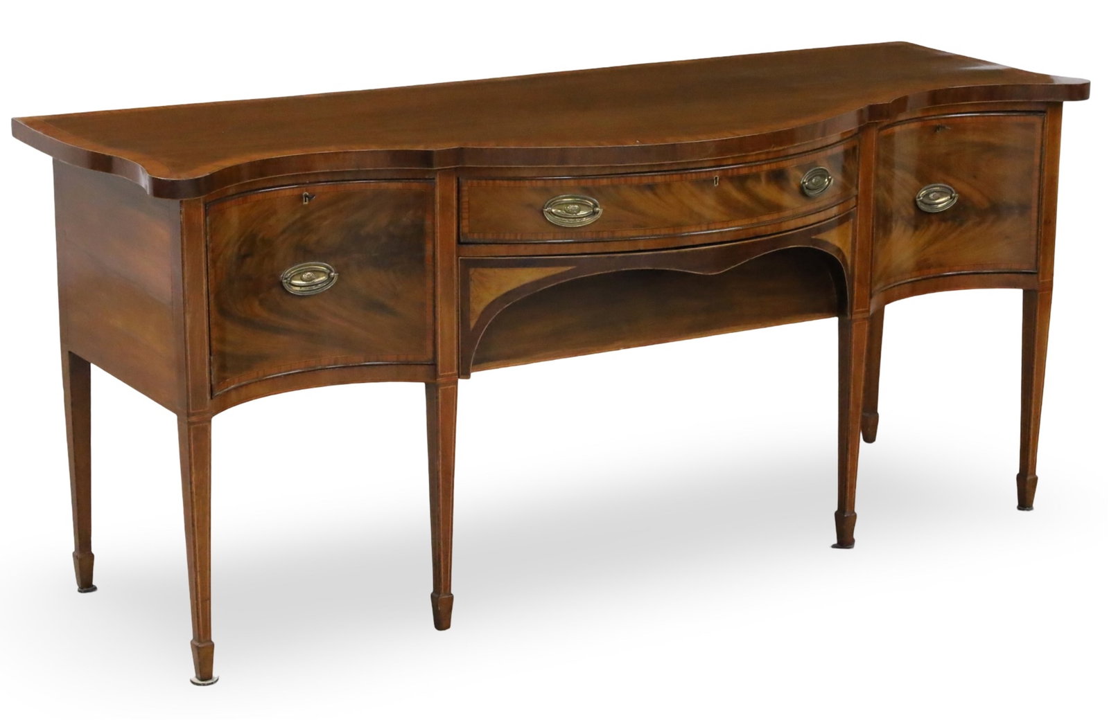 SERPENTINE HEPPLEWHITE ENGLISH MAHOGANY SIDEBOARD: Fine serpentine Hepplewhite English mahogany sideboard with satinwood crossbanded top over two rectangular drawers and one wine drawer with opposing swing door exposing open cavity having similiar ban