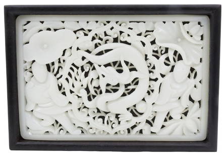 FINE CHINESE WHITE JADE PANEL BOX: Finely carved Chinese white jade panel, deep open work carving depicting center dragon with two flanking attendants under lotus blooms, late 19th/early 20th century, mounted in lid of a teakwood vanit