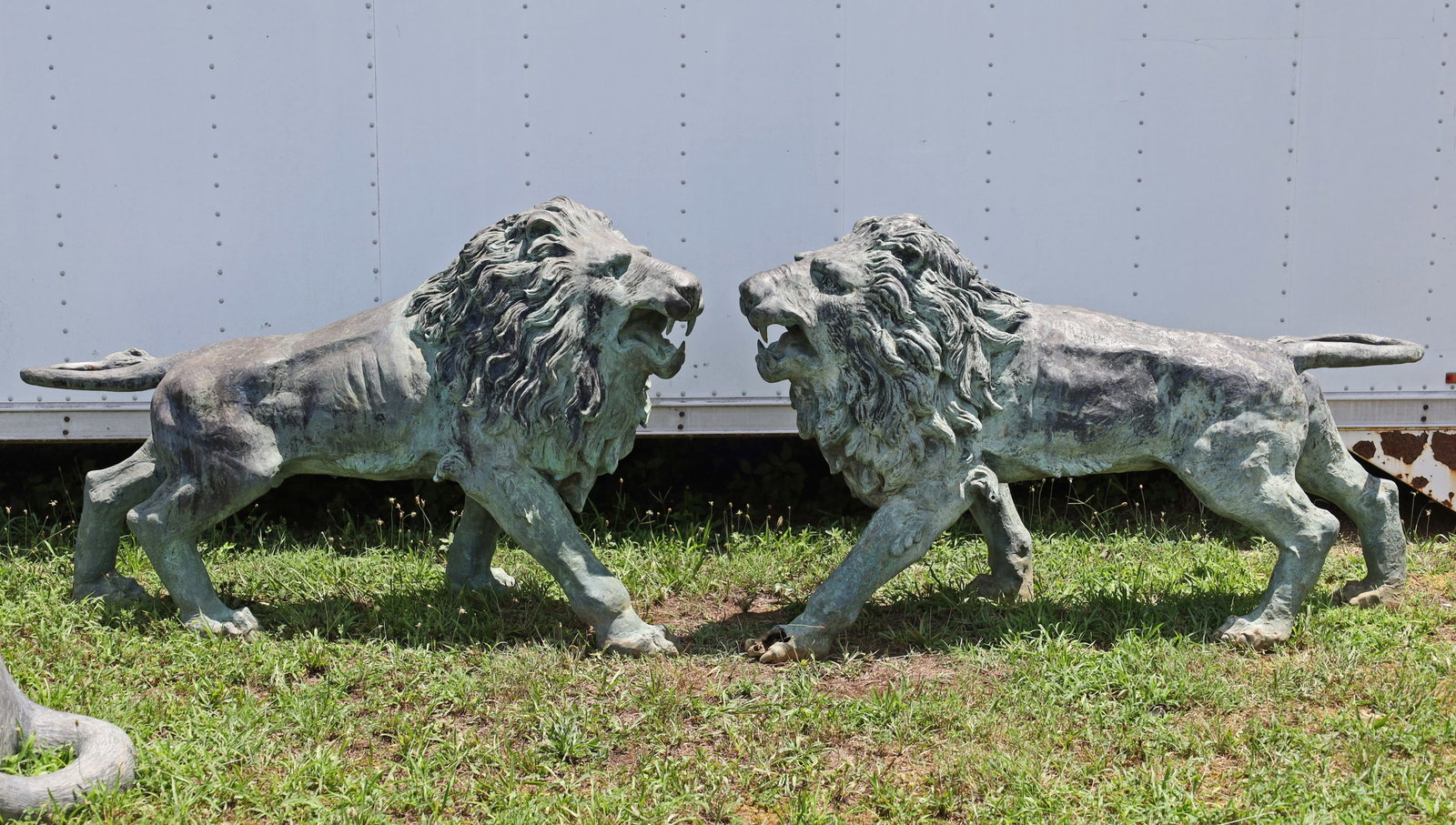 PAIR OF BRONZE GARDEN LIONS: Pair of bronze garden lions, 20th century; each 41"H 67"L 19"W; Condition: one lion with damage to paw