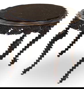 FRENCH WALNUT MARBLE TOP GUERIDON TABLE: French walnut gueridon table having varieated black marble top, scroll and rosette carved apron, raised on cabriole legs, late 19th century; 24"H 29"Diameter