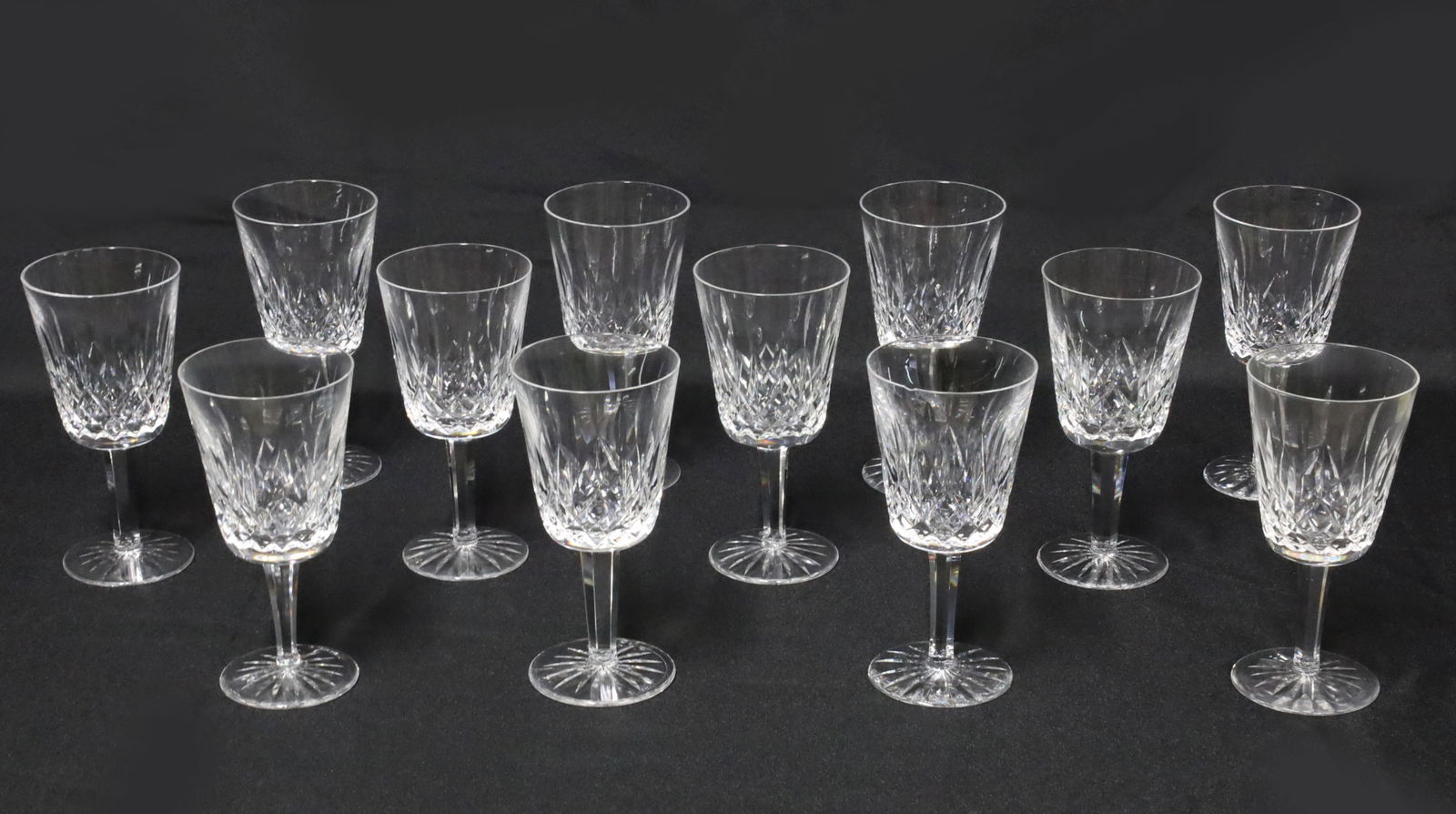 12 WATERFORD CRYSTAL GOBLETS, LISMORE: Set of twelve crystal stemware goblets, Lismore pattern, Waterford, marked on reverse: each 7"H; Condition: two goblets with observed chips to rims, see photos