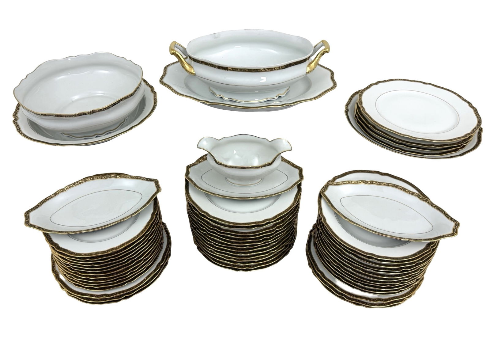 56PC. LIMOGE PORCELAIN DINNER SERVICE: 56 pc Limoges white porcelain dinner service with scalloped rims and gold ornate raised borders. 24 dinner plates, 12 salad plates , 12 soup bowls, 2 round serving dishes, I tureen with underplate, gr