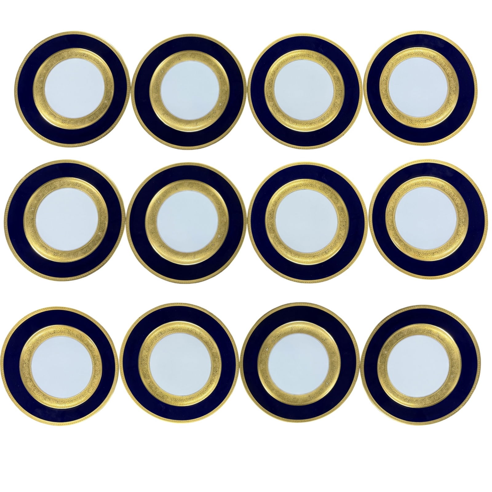 12 GERMAN COBALT AND GILT PORCELAIN DINNER PLATES: Set of twelve cobalt porcelain dinner plates or chargers, having gilt overlay borders with greek key and scroll raised relief design, marked Germany on reverse, early 20th century; each 11" Diameter