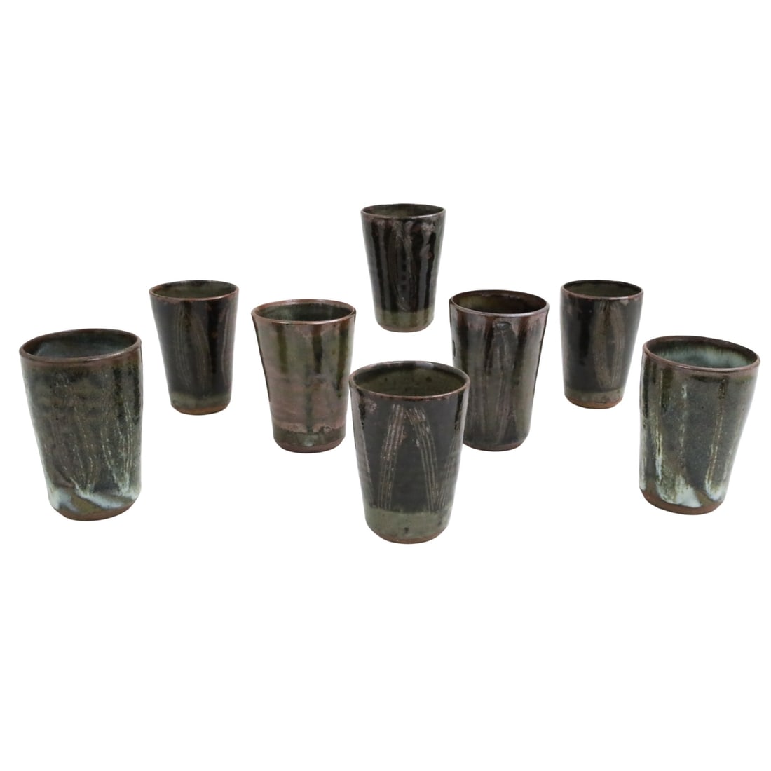 LADI KWALI (NIGERIAN, c.1925-1984): Collection of eight associated African drip glaze earthenware pottery beakers by Ladi Kwali, Abuja school, Nigeria, each stamped by artist with Ajami seal; each approximately 5"H; Provenance: Estate o