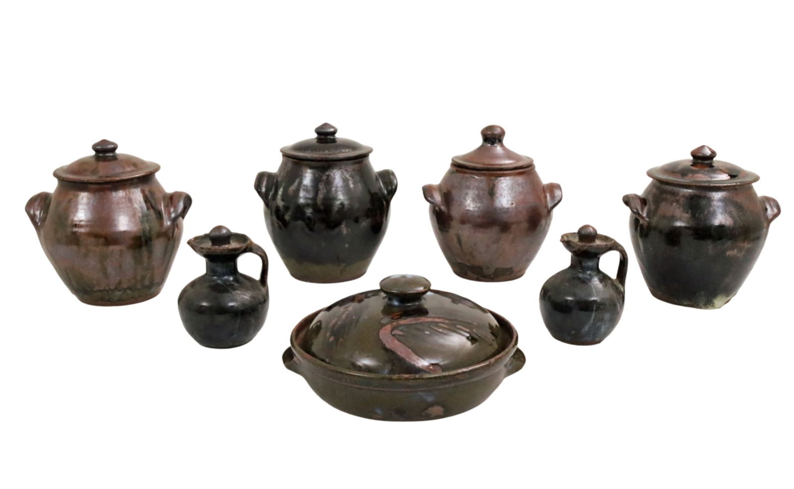 7 PC LOT OF ABUJA POTTERY: Seven piece collection of African drip glaze earthenware pottery, Abuja school, Nigeria, including four lidded double handled jars, a covered casserole, and pair of cruets, each stamped by artist with