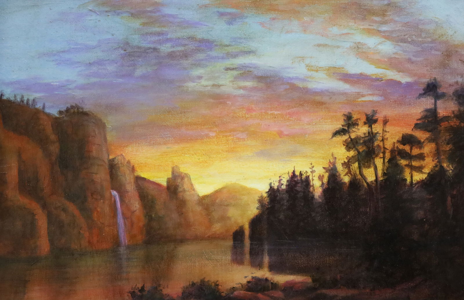 YOSEMITE VALLEY SUNSET, AFTER BIERSTADT: Luminist oil on canvas landscape painting depicting sunset in the Yosemite Valley, inspired by the works of Albert Bierstadt, bearing his signature lower right, mounted in oak frame, early 20th