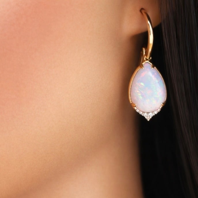 14K OPAL DROP EARRINGS: 14k yellow gold opal drop earrings having 9.27 ct of white fire opals. total weight 10grams. Please see all photos and appraisal for $11,240. Note: This lot must be paid by bank wire transfer.