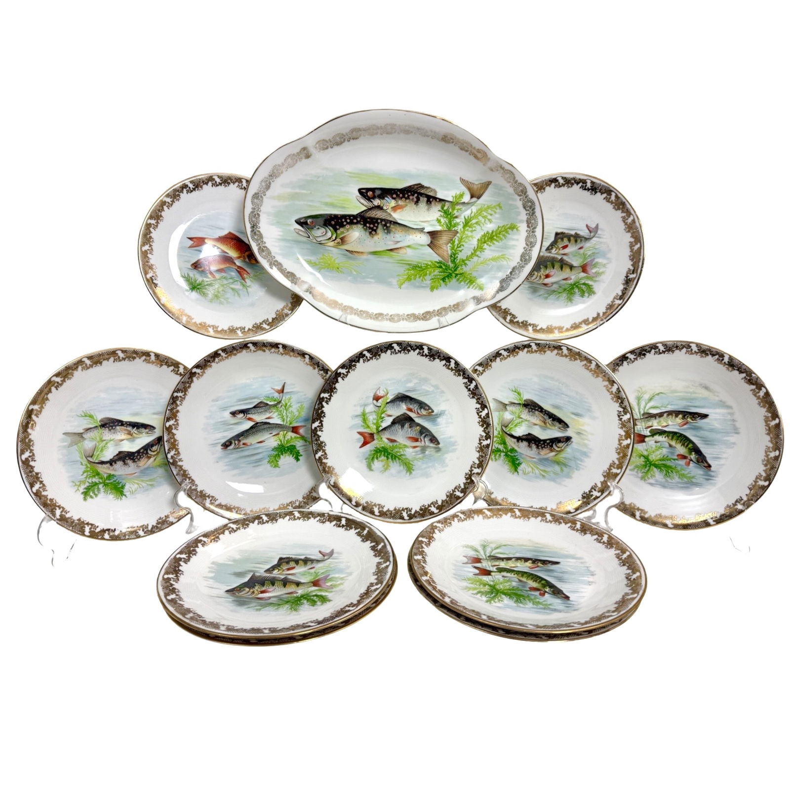 LIMOGE FISH SET: Limoge fish set having 11 round plates with gold floral scrolling border and one platter 16.5"