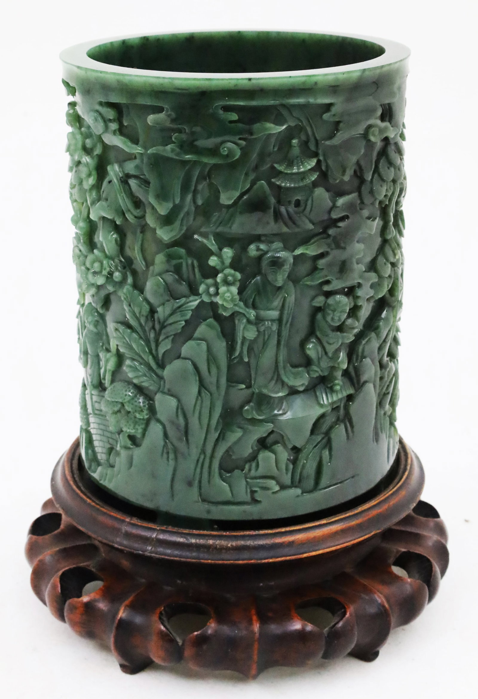CHINESE SPINACH JADE BRUSH POT: Intricately carved Chinese spinach jade brush pot depicting figures in a landscape, resting on four block feet and raised on fitted carved teakwood stand; pot 7"H 5"W 9.25"H on stand