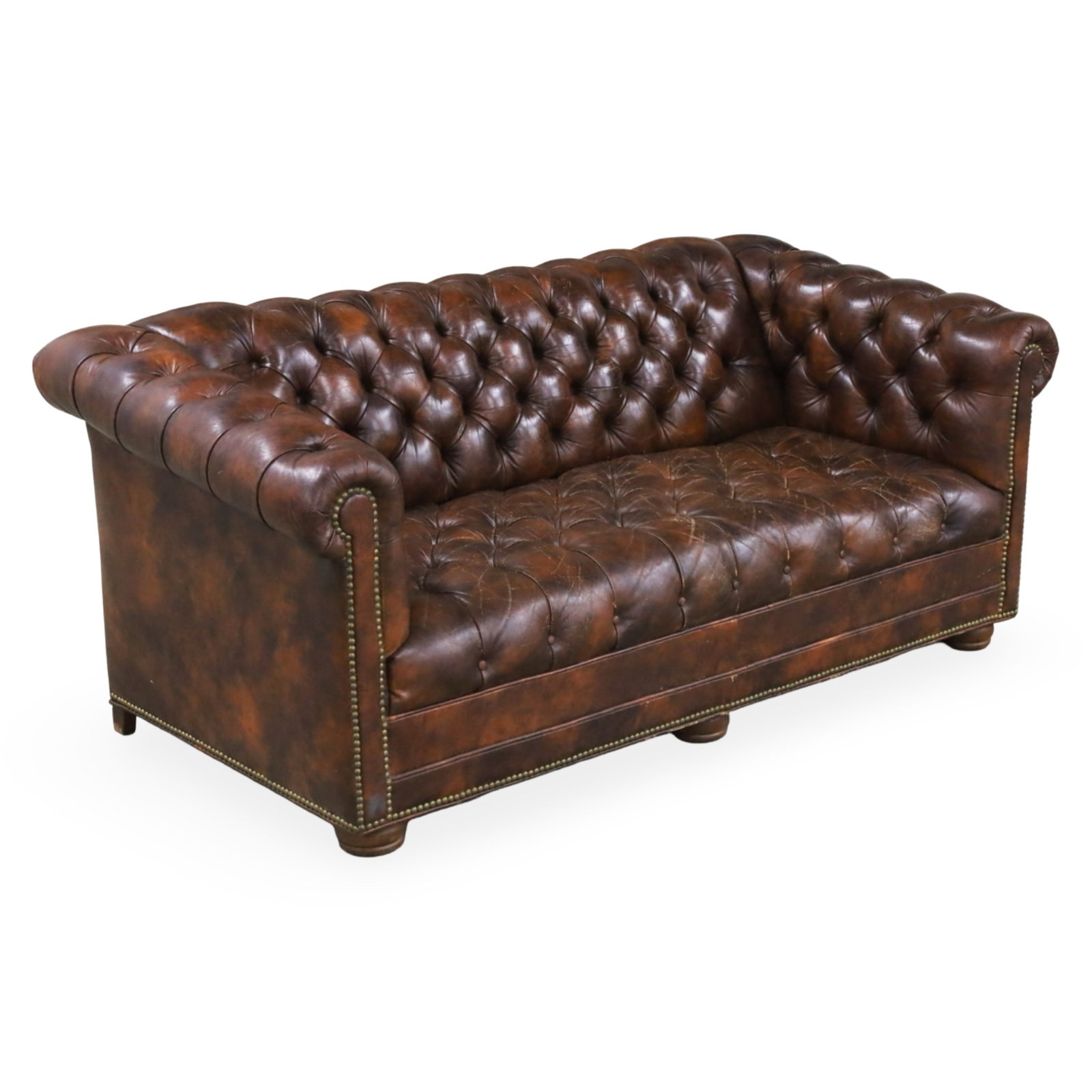CHESTERFIELD BROWN LEATHER SOFA: Chesterfield style brown leather sofa with button tufting and brass nailhead trim, early 20th century; 29"H 69"W 34"D