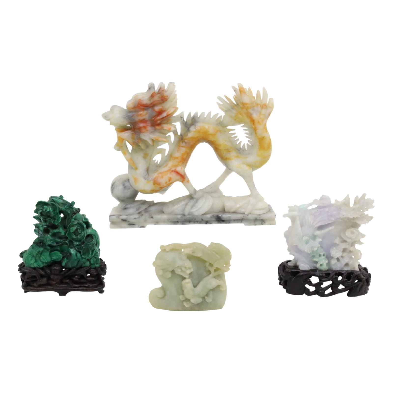4PC LOT OF CHINESE CARVED STONE: Four piece lot of Chinese carved stone, including a nephrite jade dragon, a malachite mound carving of phoenix and floral, a white jade carved of guanyin, and a small jade foo dog carving; largest dra