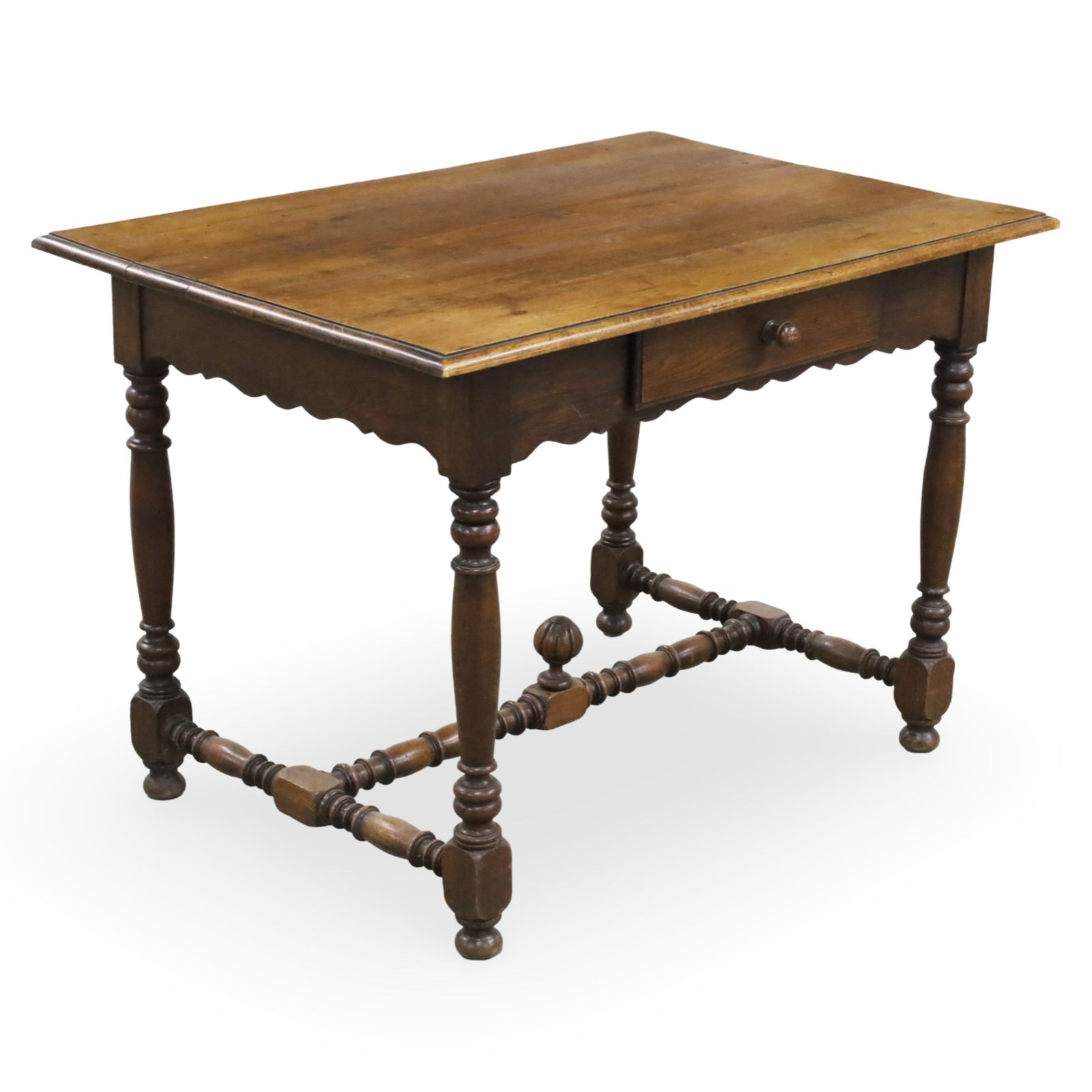 FRENCH WALNUT WRITING TABLE, 19TH C.: French walnut writing table, the shaped apron holding a single drawer, raised on turned legs and stretcher, late 19th century; 30"H 43"W 29"D