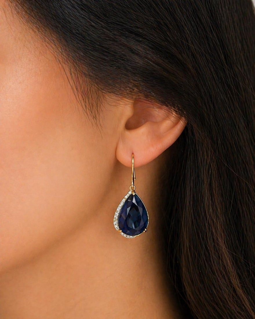 14K SAPPHIRE AND DIAMOND EARRINGS: 14k yellow gold shepherd's hook drop earrings with 2 sapphires weighing 33.70 carats and 46 round brilliant diamonds weighing .40cts. total weight of 11.2grams. sapphires measure 19 x 14mm each. Pleas