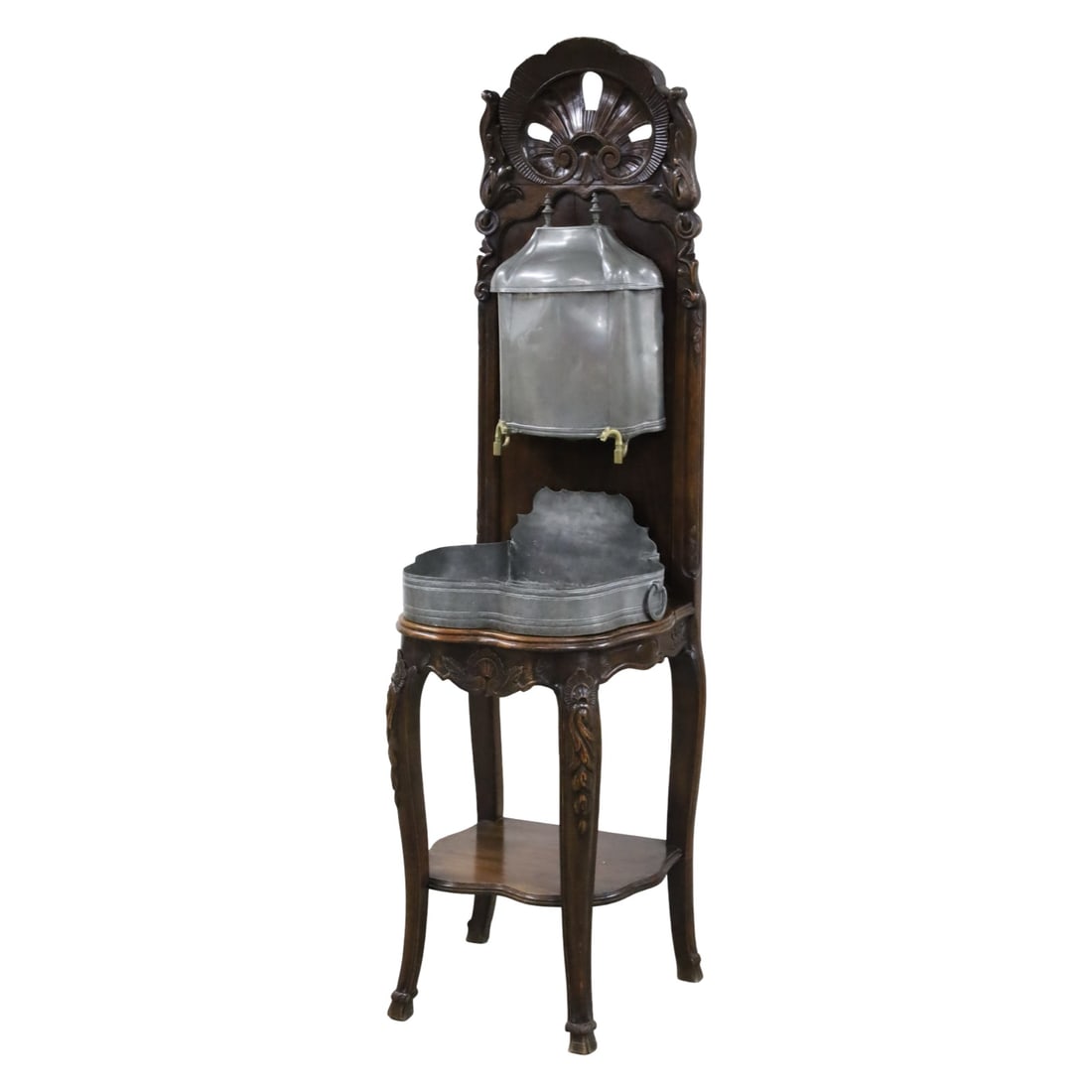 FRENCH LOUIS XV WALNUT AND PEWTER LAVABO, 19TH C.: French Louis XV lavabo or washstand, having pewter reservoir and basin, the walnut frame elaborately carved with openwork shell crest rail, decorated apron, and raised on cabriole legs, early 19th cen