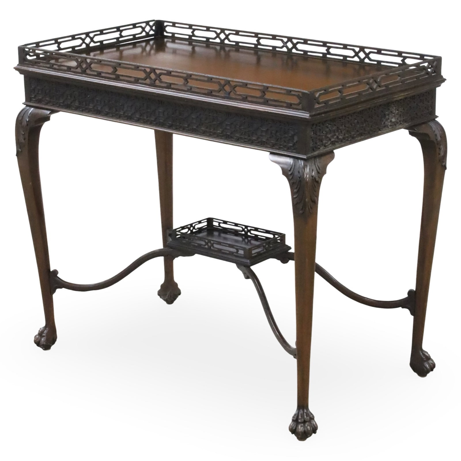 IRISH MAHOGANY SILVER TABLE, 19TH C.: Irish mahogany silver table with open work gallery over fretwork frieze having acanthus leaf carved cabriole legs resting on claw feet with conforming raised platform shelf, late 19th century; 38"H