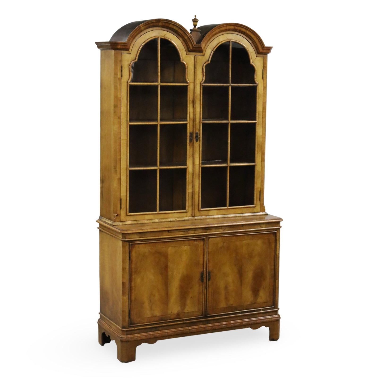 GEORGIAN STYLE WALNUT BOOKCASE: Georgian style walnut double bonnet bookcase with glass mullion doors, resting on ogee bracket feet, 20th century; 82"H 45"W 17"D